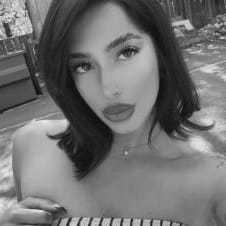 Portrait of Mikayla, a professional stylist at Studio 455 Salon, showcasing their expertise and style.