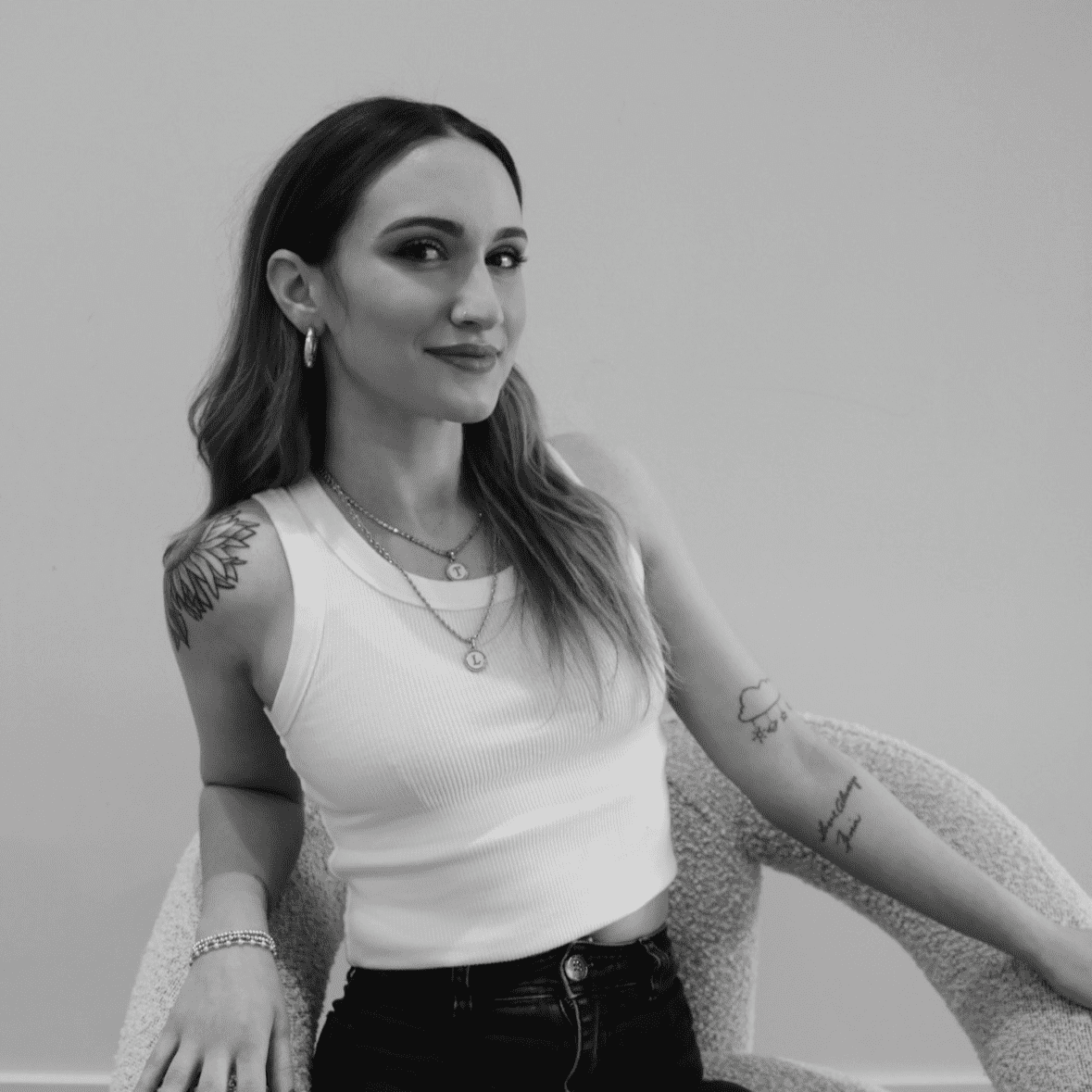 Portrait of Gina, a professional stylist at Studio 455 Salon, showcasing their expertise and style.