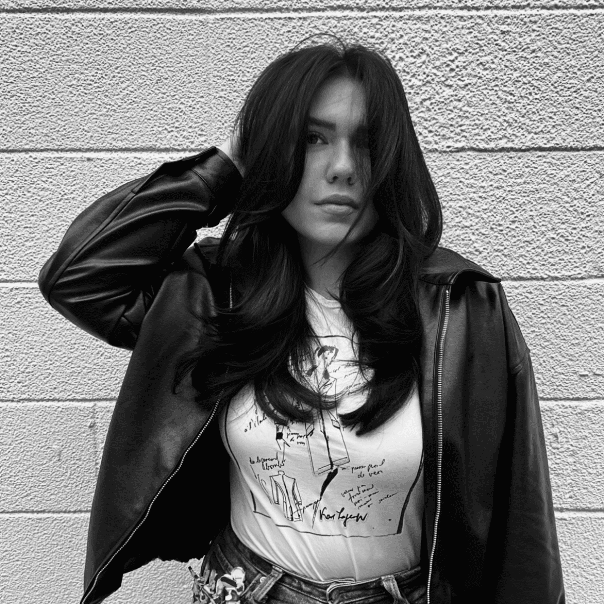 Portrait of Jehona, a professional stylist at Studio 455 Salon, showcasing their expertise and style.